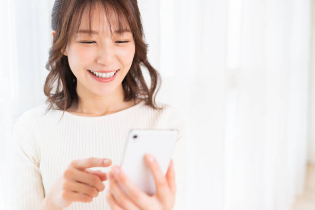 istock attractive Asian woman using a smart phone 1395994355
