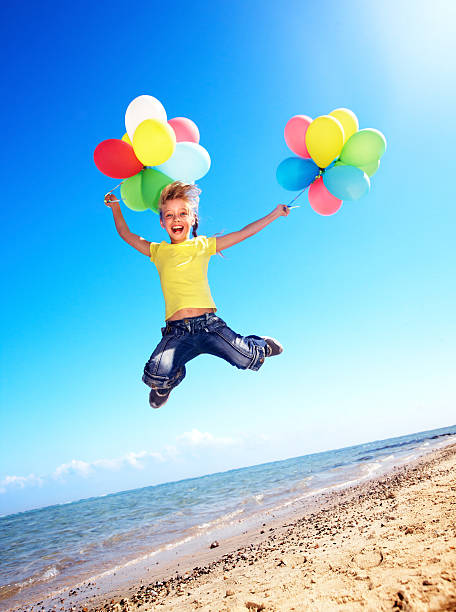 istock Child playing with balloons at the beach 139599436