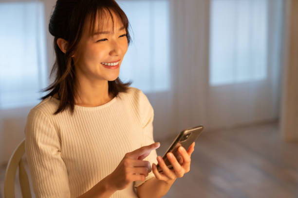 istock attractive Asian woman using a smart phone 1395994389