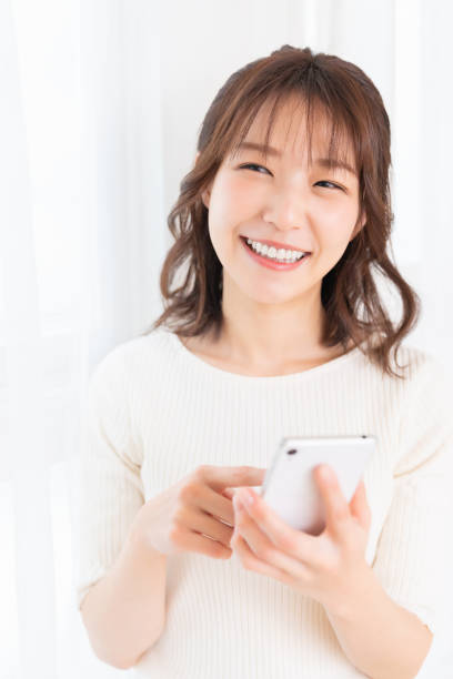 istock attractive Asian woman using a smart phone 1395994390