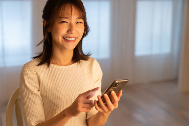 istock attractive Asian woman using a smart phone 1395994405