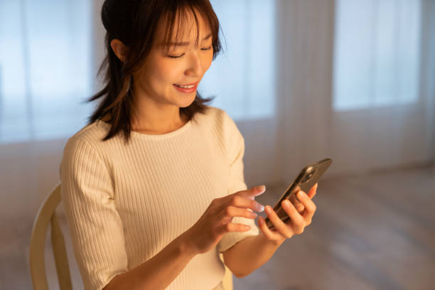 istock attractive Asian woman using a smart phone 1395994449