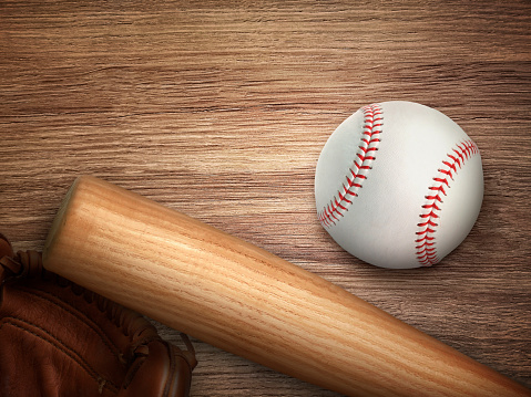 Baseball bat, glove and ball on wooden floor. Sport theme background with copy space for text and advertisment