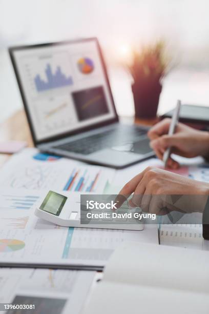 Financial Businesswomen Analyze The Graph Stock Photo - Download Image Now - Financial Bill, People, Accountancy