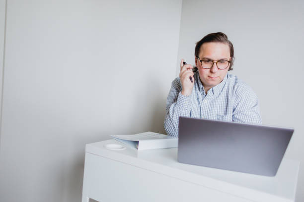 istock Business man Working From Home Office with Laptop and White Binder 1396004591