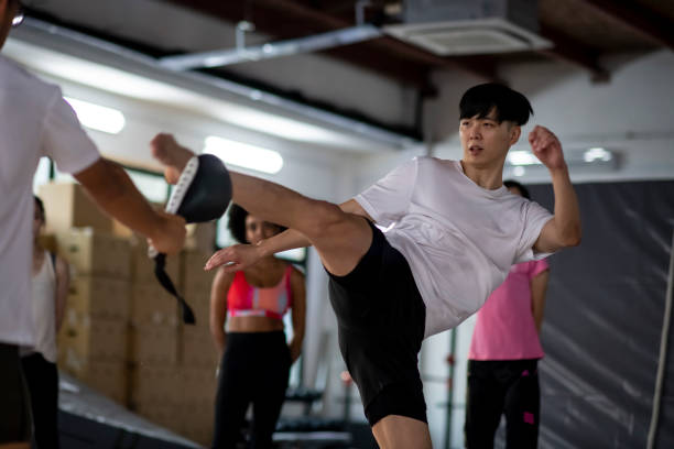 Muscular Male Asian Chinese Practising Kickboxing