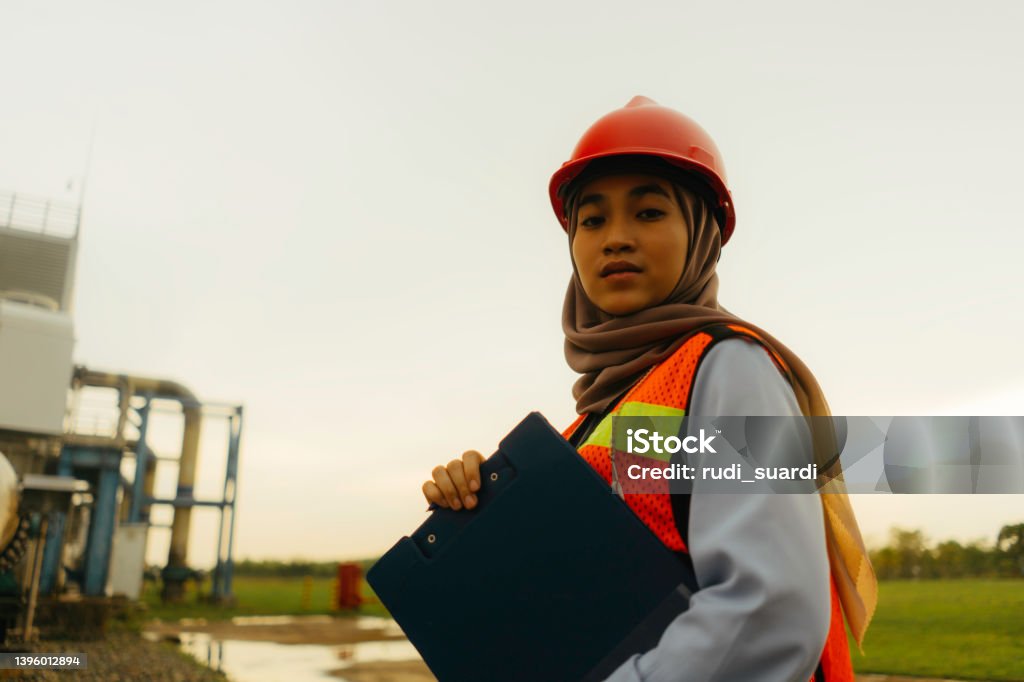 Portrait of young beautiful engineer woman working in factory building Indonesia Stock Photo