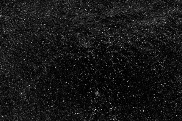 istock Rugged black metal sheet with scattered white grunge texture 1396013954