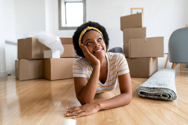 istock Pensive woman moving house and packing in boxes 1396019869