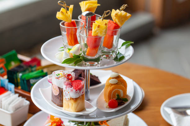 istock Mixed tropical fruit skewers, cakes, cookies, afternoon tea set for two persons 1396020957