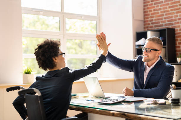 istock Disabled Businessman Giving High Five To His Partner 1396023454