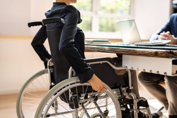 istock Disabled Businessman Sitting On Wheelchair 1396023464