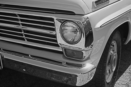 Black and white.   Driver’s side headlight, bumper, and tire.