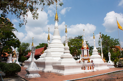 Ancient old Phra Mu Tao stupa with antique two minor chedi for thai people travelers travel visit respect praying blessing holy worship at Wat Chomphuwek or Chumpoo Wek temple in Nonthaburi, Thailand