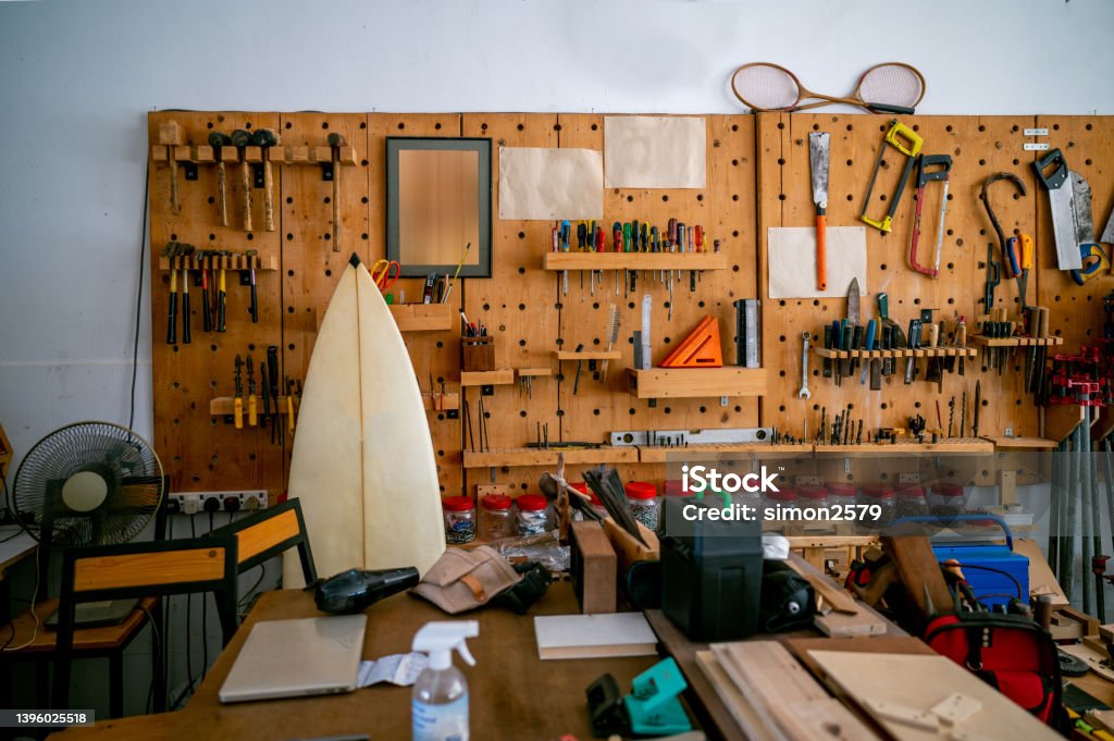 Various carpenter hand tools hanging on the wall in the carpentry workshop. Shelf with hand tools for woodworking. Various carpenter hand tools hanging on the wall in the carpentry workshop. Hand Tool Stock Photo