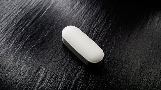 white medicine capsule pills, object photo shot macro photography