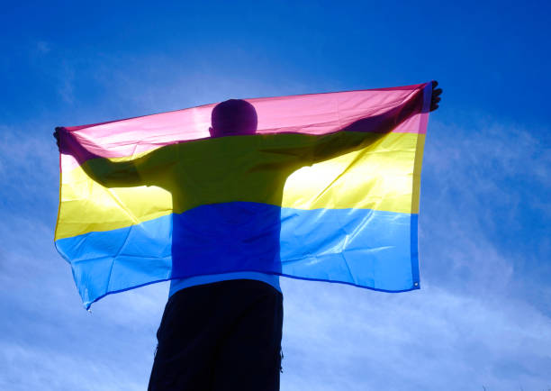 istock adult man with bisexual flag on a sunny day. 1396027754