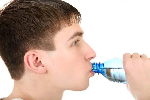 Teenager drinking the Pure Water on the White Background