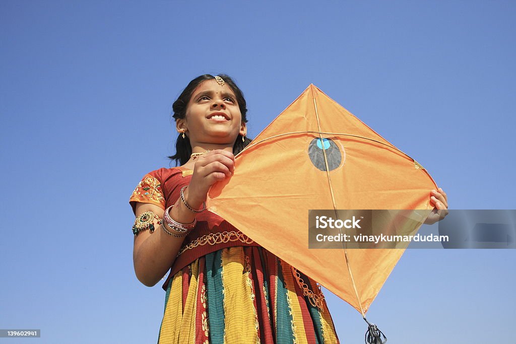 indian girl holding kite this on the occasion of Indian festival pongal.. Kite - Toy Stock Photo