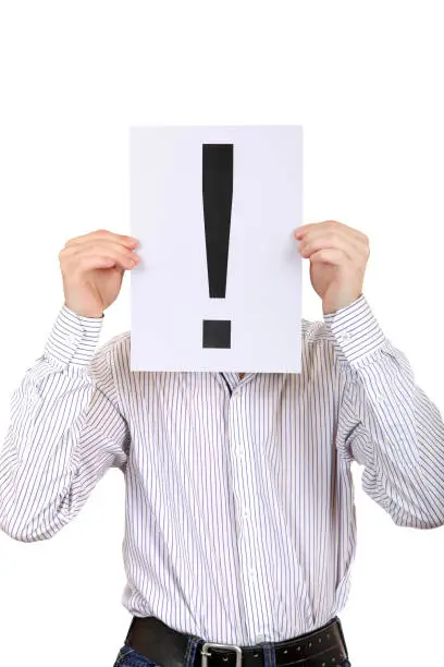 Person holds an Exclamation Mark in place of Face on the White Background