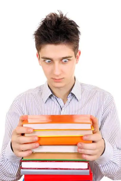 Surprised Teenager looking on the Books Isolated on the White Background