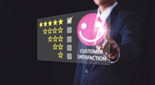 istock Customer Experience Concept, Businessman holding a smiley face sticker, and next to it there is a checkmark in the box of five stars to indicate the level of customer satisfaction 1396036435