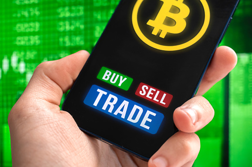 Modern way of exchange, bitcoin convenient payment method in global economy market background. Smartphone in hand. Financial investment with virtual digital currency photo