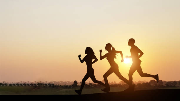 istock Silhouette of people jogging at sunset 1396040541