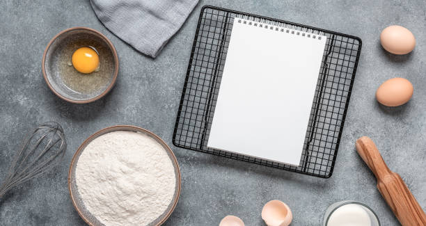 istock Baking ingredients and a blank notepad on a gray concrete background. Top view, flat lay. Banner 1396040946