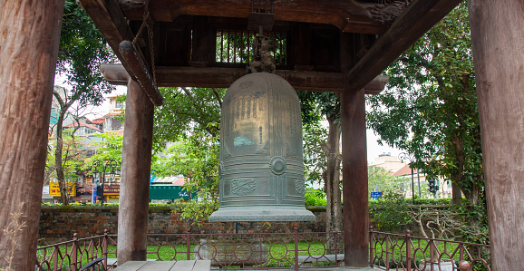 Hanoi, Vietnam - March 27, 2022: Bronze Bell in the Fifth courtyard at Van Mieu - Temple of literature, a Confucian temple with landscaped courtyards, numerous altars & shrines. The temple was built in 1070 at the time of Emperor Lý Thánh Tông and Vietnam's first national university was established within the temple.