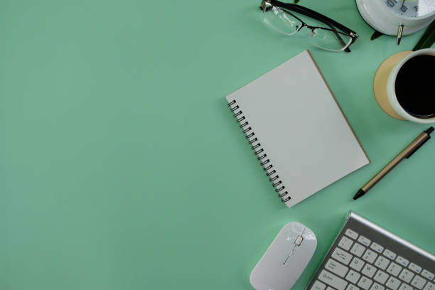 istock Office workplace table background with laptop computer, notebook and paper. Top view from above 1396043092