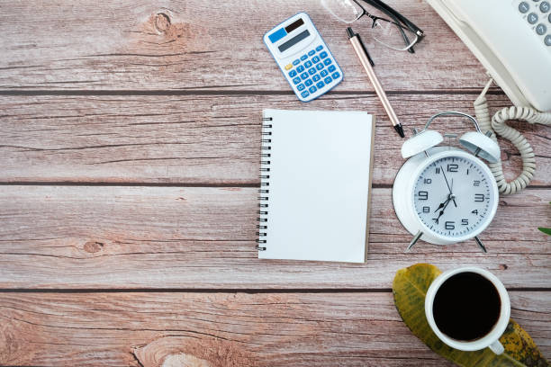 istock Office desk with keyboard computer, Pen, eyeglass, notebook, Cup of coffee on wood background, Top view with copy space, Mock up. 1396043174