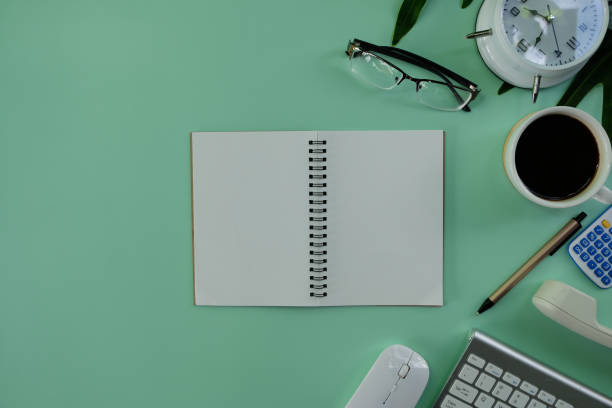istock Office workplace table background with laptop computer, notebook and paper. Top view from above 1396043177