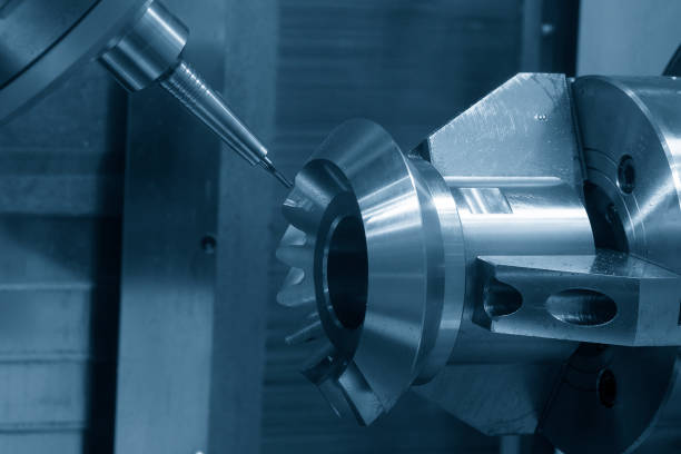 The 5-axis CNC milling machine  cutting the metal gear part. stock photo
