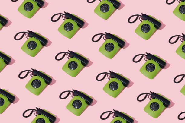 istock Retro 80s green rotary dial corded landline telephone pattern on pink background. Minimal concept. 1396047265
