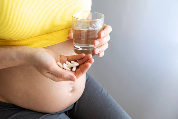 istock Pregnant and pills 1396048494