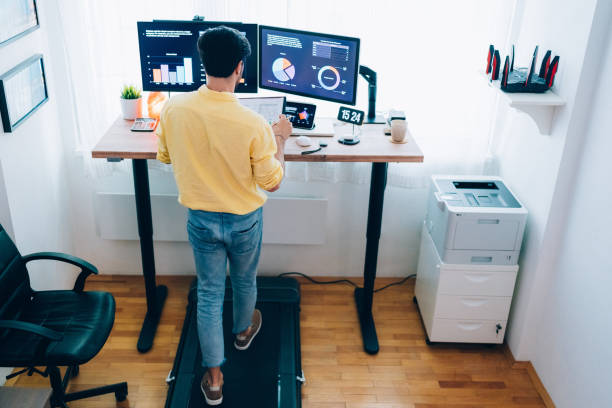 istock Standing desk home office with under desk treadmill 1396051598