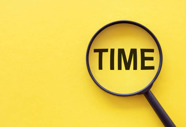 istock Time Word written on magnifier glass. Search time concept. 1396052587