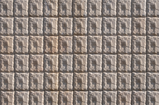 Stone wall made of figure stone tiles. Geometric background image