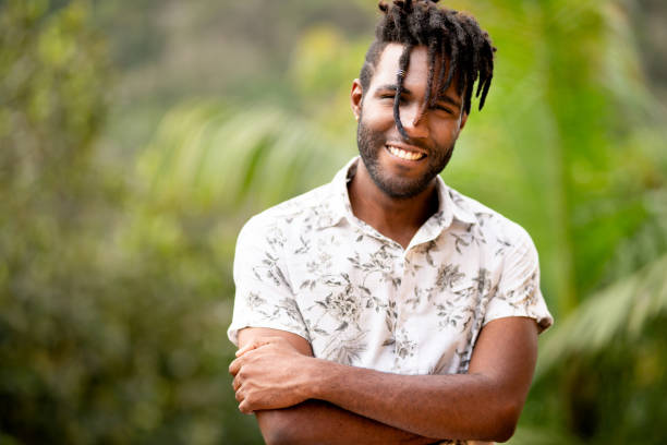 istock Smiling young man standing on a balcony overlooking a scenic forest 1396053590