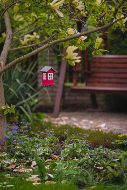 istock Decorative feeder and wooden bench in the garde 1396054058