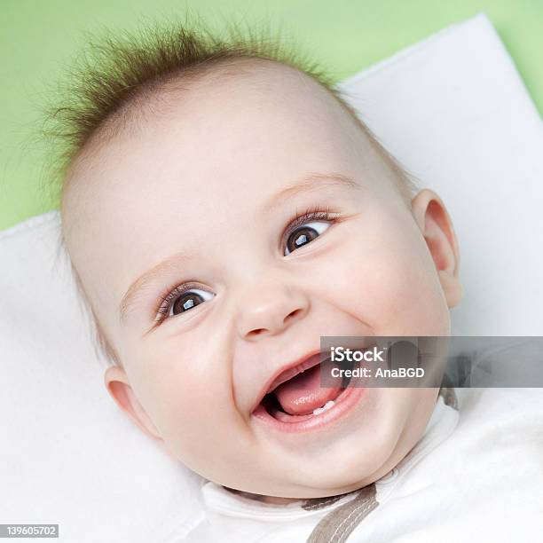 A Young Baby Smiling Showing First Teeth Stock Photo - Download Image Now - Number 1, Baby - Human Age, Happiness
