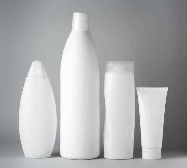 istock Mockup with set of different white clean shampoo bottles on gray background 1396057808