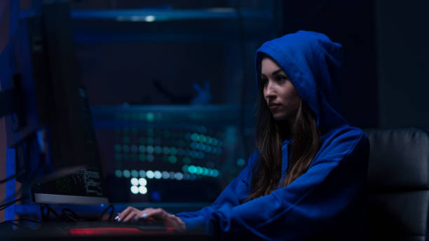 istock Young woman hacker by computer in the dark room at night, cyberwar concept. 1396058355