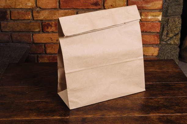Craft paper bag on a wooden table stock photo
