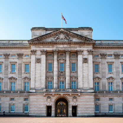 London, England, UK - 20th June 2015: Wide angle view of Buckingham Palace illuminated in early morning sunlight.