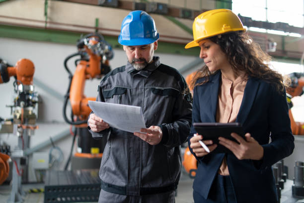 istock Female engineering manager and mechanic worker doing routine check up in industrial factory 1396062488