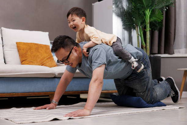 istock The father is doing push ups and the son is sitting on his back. 1396064375