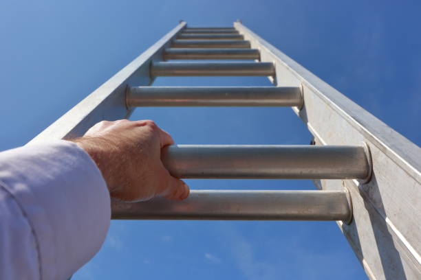 istock Hands climbing a ladder to the sky 1396064581
