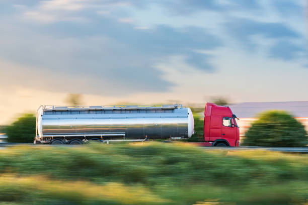 istock Tanker truck driving fast on the highway, side view, sweep effect. 1396064659